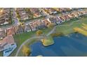 Aerial view of homes on a golf course with a nearby lake at 13231 Woodford St, Orlando, FL 32832