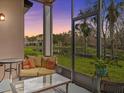 Relaxing screened patio with comfortable seating overlooking serene pond and lush greenery at 1431 Milledge Ln, Davenport, FL 33896