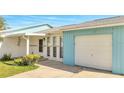 Close-up of the front exterior with an attached garage and an inviting front entrance with beautiful curb appeal at 161 Laurel Way, Kissimmee, FL 34743