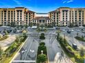 An aerial view of a beautiful community entrance and luxurious condos surrounded by lush landscaping at 16300 County Road 455 # 607, Montverde, FL 34756