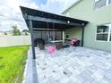 Backyard patio featuring pavers, grill and lounge seating under a covered pergola at 2029 Maple Ridge Dr, Zellwood, FL 32798