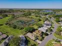 Expansive aerial view of a lush residential area, showcasing community lakes and natural landscape at 21636 King Henry Ave, Leesburg, FL 34748