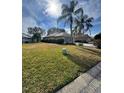 Backyard view showcasing the home's layout and well-manicured lawn at 21636 King Henry Ave, Leesburg, FL 34748