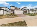 Charming two-story home featuring a brick driveway and a well-manicured front yard at 2242 Huntsman Ridge Rd, Clermont, FL 34715