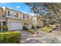 Attractive townhome featuring a brick driveway and a well-kept yard in a desirable neighborhood setting at 3257 Villa Strada Way, Orlando, FL 32835