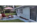 Backyard patio area with outdoor table, chairs, and string lights, perfect for entertaining at 3807 March Ave, Orlando, FL 32806