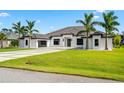 Contemporary home showcasing a sleek design, well-manicured lawn, and a spacious driveway with a three-car garage at 3845 S Stillwood Ln, Lake Mary, FL 32746