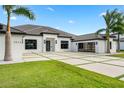 Chic home boasting an expansive driveway, a tile roof, a three-car garage, and pristine landscaping at 3845 S Stillwood Ln, Lake Mary, FL 32746