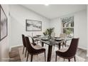 Elegant dining room featuring a glass-top table and a large window offering natural light at 5247 Secluded Oaks Dr, Orlando, FL 32812