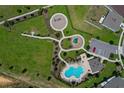 Aerial view of a community park with a pool, playground, and green space at 9180 Carmela Ave, Davenport, FL 33897