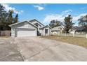 A charming single-story home with an attached two-car garage on a sunny day at 9307 Echo Run, Orlando, FL 32817