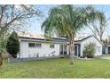 Attractive single-story home featuring a palm tree and solar panels for energy efficiency at 9544 Brimton Dr, Orlando, FL 32817