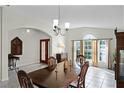 Elegant dining room featuring a large wooden table set and a window providing natural light at 9848 Nonacrest Dr, Orlando, FL 32832