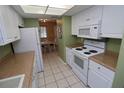 Efficient kitchen featuring white appliances, white cabinets, and a bright atmosphere at 1104 Southampton Dr # 3, Port Orange, FL 32129