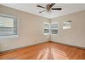 Bright bedroom with hardwood floors, ceiling fan, and multiple windows for ample natural light at 1523 Silver Star Rd, Orlando, FL 32804