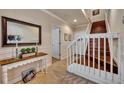 Welcoming foyer with a staircase, elegant wainscoting, and decorative console table at 1725 Prospect Ave, Orlando, FL 32814