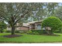 Mature trees frame this home with well-maintained landscaping at 1921 Redwood Grove, Lake Mary, FL 32746