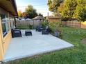 A home's backyard has a concrete patio with a fenced-in yard at 210 Dartmouth St, Deltona, FL 32725