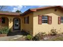 Exterior view of a charming home, showcasing arched entryway and warm accents at 210 Dartmouth St, Deltona, FL 32725