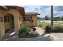 Charming home exterior showcasing a manicured front yard with mature landscaping and unique architectural details at 210 Dartmouth St, Deltona, FL 32725