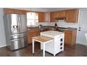Modern kitchen featuring stainless steel appliances, updated countertops, and a stylish kitchen island with butcher block top at 210 Dartmouth St, Deltona, FL 32725
