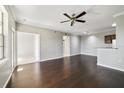 Open-concept living area with hardwood floors, a ceiling fan, and neutral walls leading into a dining area at 2624 Robert Trent Jones Dr # 634, Orlando, FL 32835