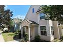 Side exterior view of a two-story townhome with well-maintained landscaping and sidewalks at 3364 Westchester Square Blvd # 104, Orlando, FL 32835