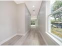 Long hallway with wood floors and window at 39 N Sunset Dr, Casselberry, FL 32707