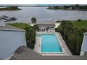 Overhead shot of a community pool with lake views, a bar area, and palm trees on a bright day at 4117 Fairview Vista Pt # 105, Orlando, FL 32804