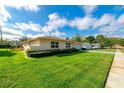 Beautifully landscaped front yard featuring a lush green lawn and mature, manicured shrubs at 4416 Flagg St, Orlando, FL 32812