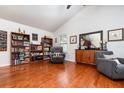 Cozy living room featuring hardwood floors, a vaulted ceiling, comfortable seating, and ample natural light at 445 Autumn Oaks Pl, Lake Mary, FL 32746