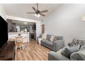 Cozy living room featuring wood flooring, a ceiling fan, and neutral paint, creating a warm and inviting atmosphere at 537 Martin Place Blvd, Apopka, FL 32712