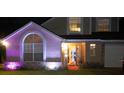 Exterior view of a home with a pink glow showcasing its architectural details and landscaping at 7138 Hiawassee Bent Cir, Orlando, FL 32818