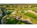 Scenic aerial view of a meticulously maintained golf course with sand traps and rolling green hills at 7433 Excitement Dr, Reunion, FL 34747