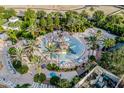 Aerial view of a colorful resort water park with slides, sprinklers, and plenty of seating at 7433 Excitement Dr, Reunion, FL 34747