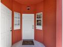 Close-up of the bright white front door entry with a charming welcome mat at 8523 Crystal Cove Loop, Kissimmee, FL 34747