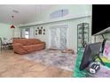 Bright living room features tile flooring, high ceilings, and double doors to the backyard at 8982 Fort Jefferson Blvd, Orlando, FL 32822