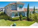 Rear view of a two-story home highlighting well-maintained landscaping and a tiled roof at 9406 Mere Pkwy, Orlando, FL 32832