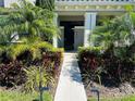 Front entrance to home with tropical landscaping at 9406 Mere Pkwy, Orlando, FL 32832