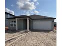 New construction single story home with a two car garage and minimalistic landscaping at 1453 Arbor Hill Dr, Deltona, FL 32725