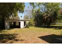 View of the spacious backyard with large trees at 1801 Riley Ave, Orlando, FL 32805