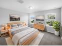 Calm bedroom featuring a comfortable bed, natural light, and minimalist decor create a relaxing space at 2033 Milkweed St, Ocoee, FL 34761