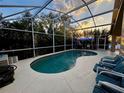 Relaxing screened-in pool area with comfortable seating and a view at 229 Silverton Rd, Davenport, FL 33897