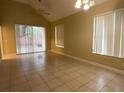 Spacious living area with sliding glass doors, tile flooring, and a ceiling fan at 2446 Temple Grove Ln, Kissimmee, FL 34741