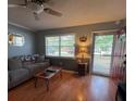 Inviting living room featuring hardwood floors, a cozy sofa, and a bright window with natural light at 2626 Balkan St, Apopka, FL 32703