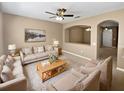 Inviting living room featuring neutral walls, plush carpeting, ceiling fan, and comfortable seating arrangement at 2840 Grasmere View Pkwy, Kissimmee, FL 34746