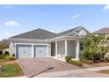 Beautiful single-story home featuring a two-car garage, covered entry, and manicured landscaping at 2993 Irish Peach Dr, Winter Garden, FL 34787