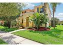 Two-story home with lush landscaping, featuring palm trees and a well-maintained lawn at 3350 Pegaso Ave, New Smyrna Beach, FL 32168