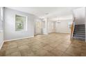 Open-concept living room featuring tile flooring, and staircase at 3350 Pegaso Ave, New Smyrna Beach, FL 32168