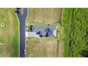 Aerial view of modern home with manicured landscaping and a sleek driveway at 336 Caladium Ave, Lake Alfred, FL 33850
